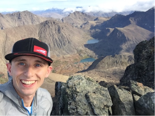 Sam Hurst taking selfie from mountain top
